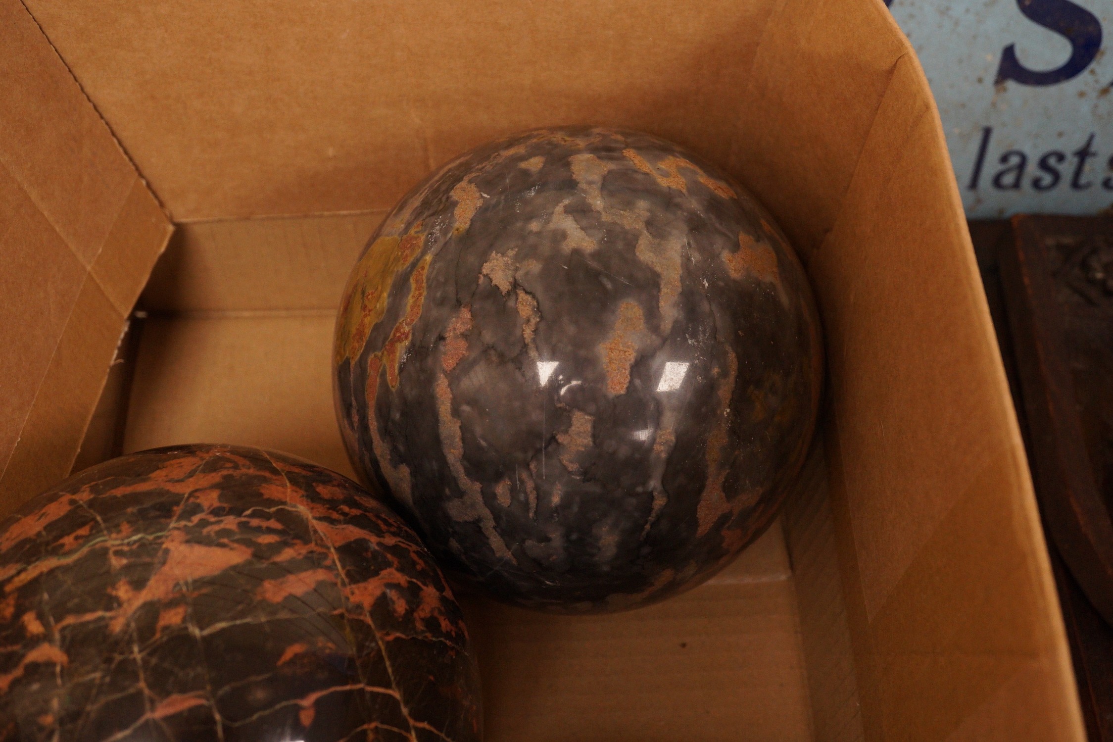 A trio of carved marble balls, largest 14.5cm